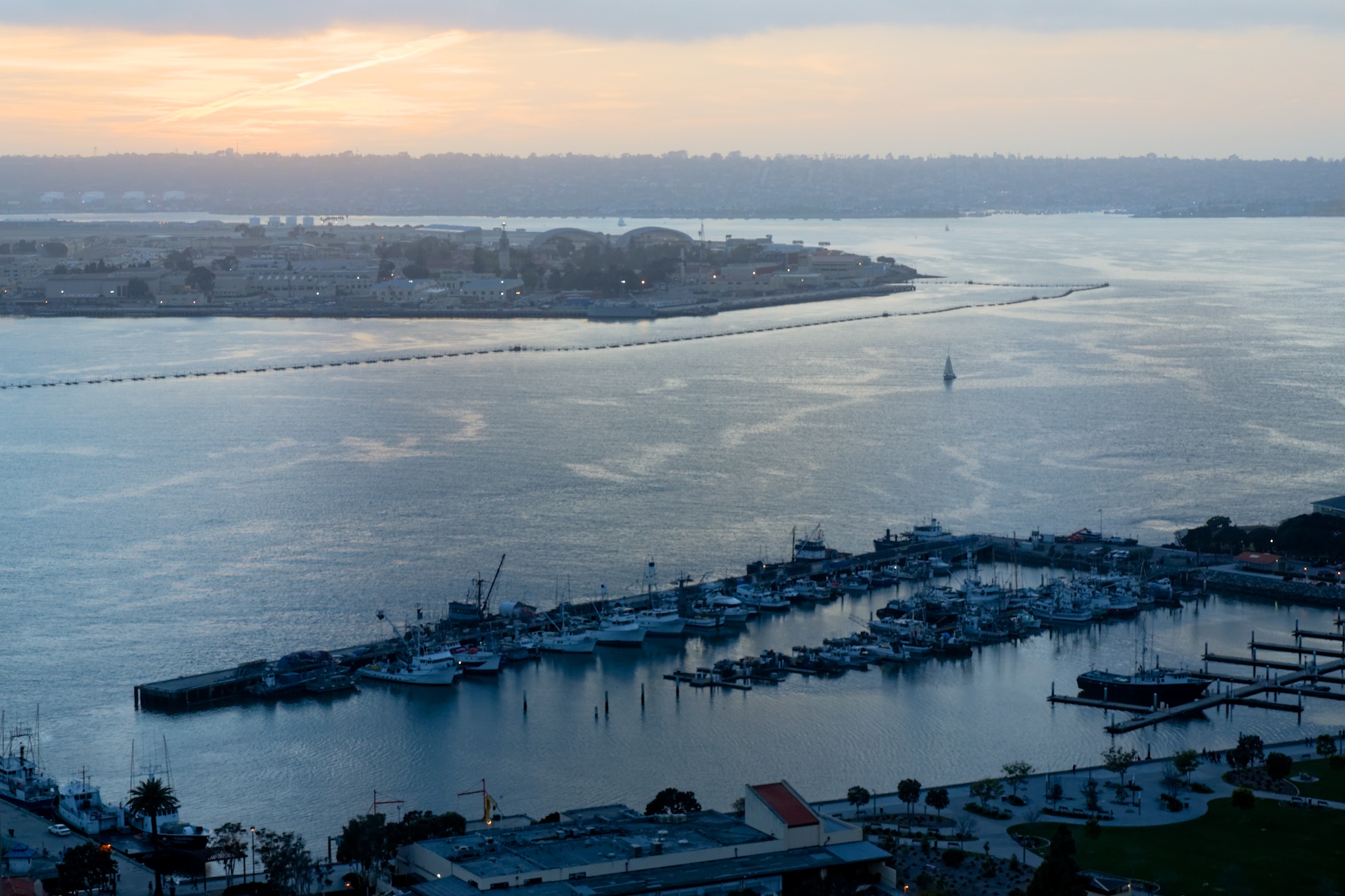 Sunset over San Diego harbour, lovely orange colours over grey water.