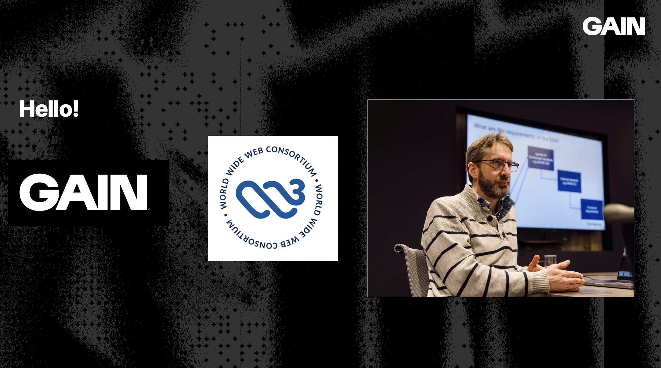 Intro slide with logos of Gain and W3C, with a picture of Alastair talking, pale jumper with dark horizontal strips, and a dark beard with pale vertical stripes.